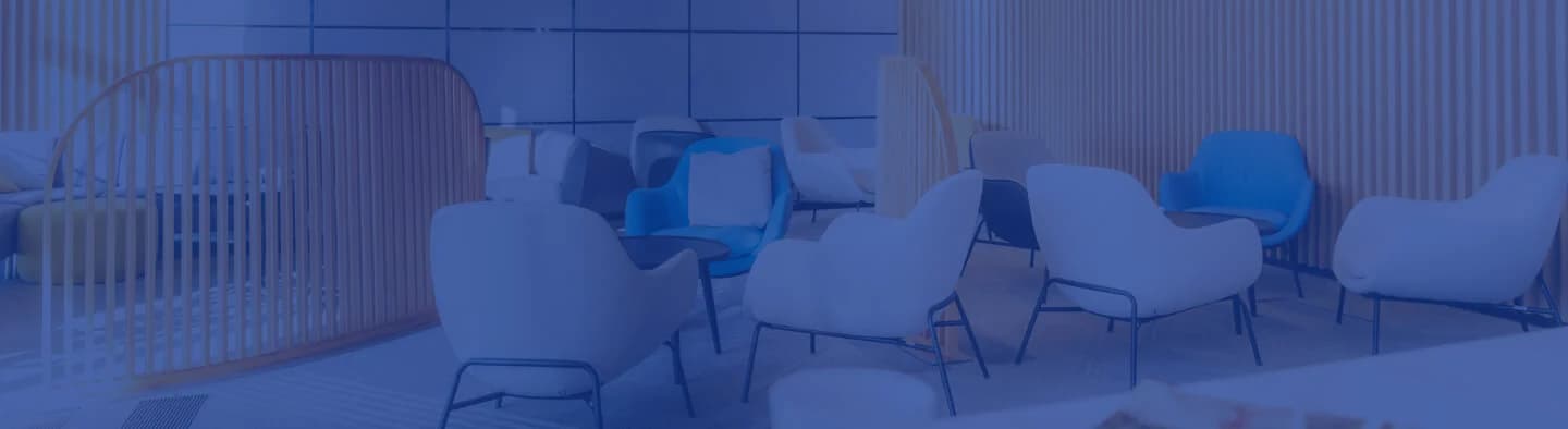 Modern waiting area with a variety of chairs in a cool blue-toned office space.